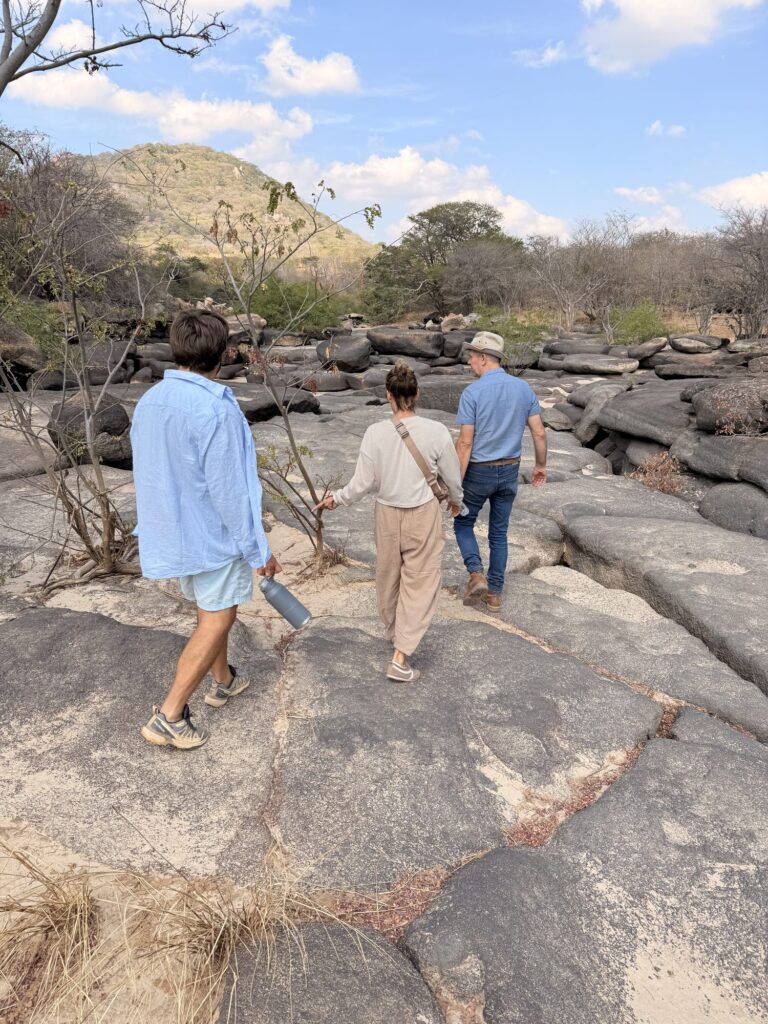 Guests walking across the rock formations at God's Bridge near Iringa