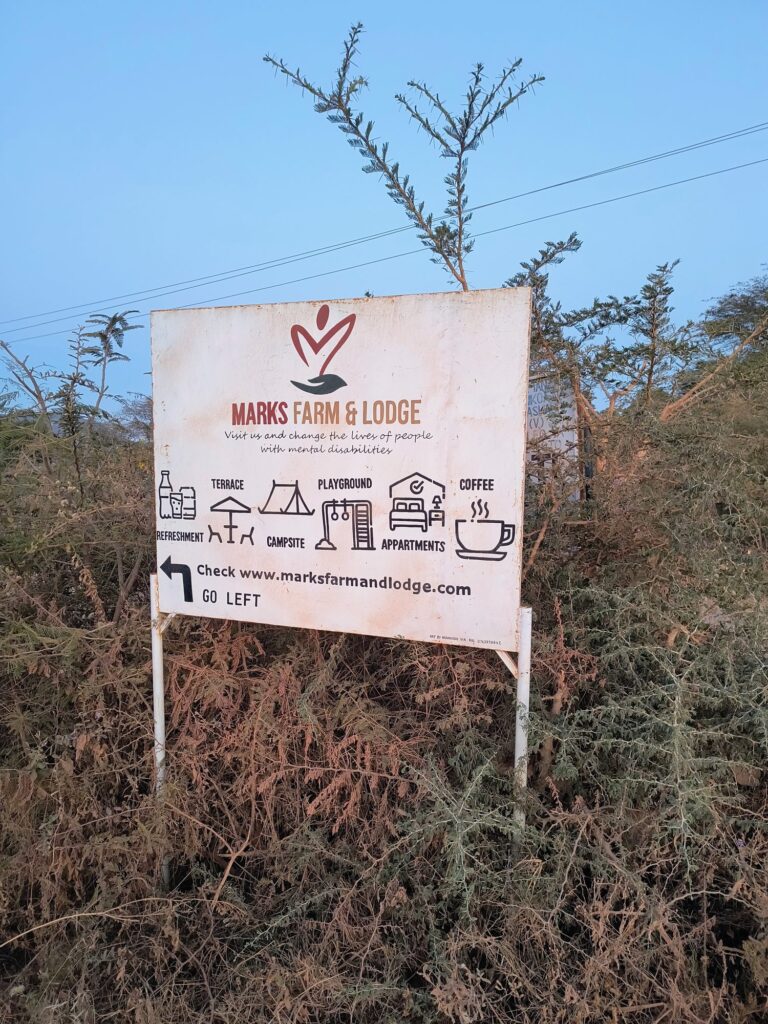 Roadside sign for MARK's Farm & Lodge on the road to Ruaha near Mangalali